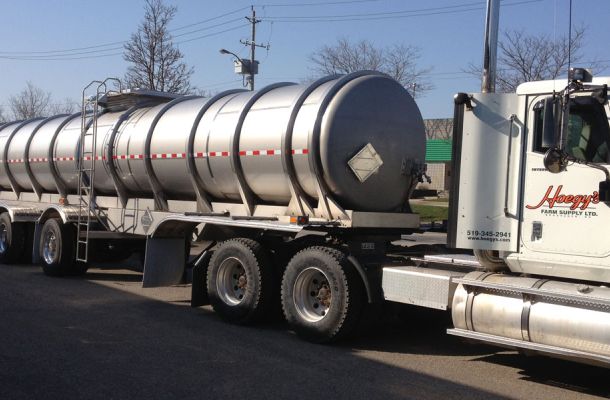 Front angle image of large truck with liquid fertilizer tanker behind