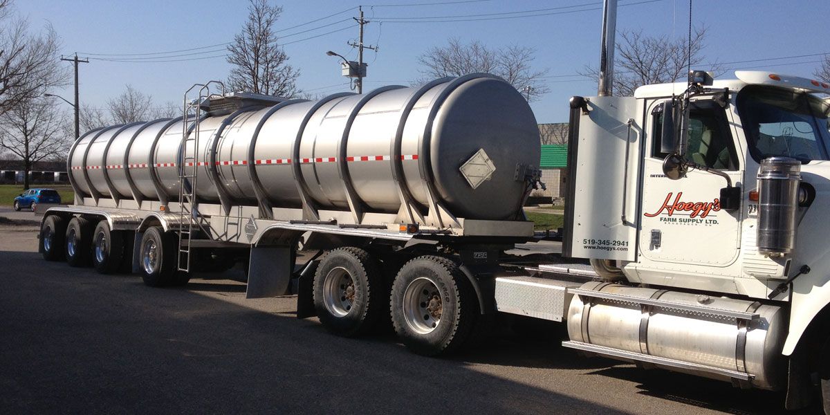 Front angle image of large truck with liquid fertilizer tanker behind